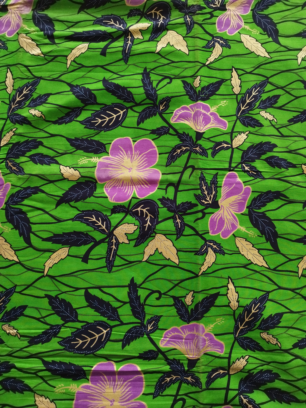 Tissu wax - hibiscus violets et dorés fond vert - par 50 centimètres